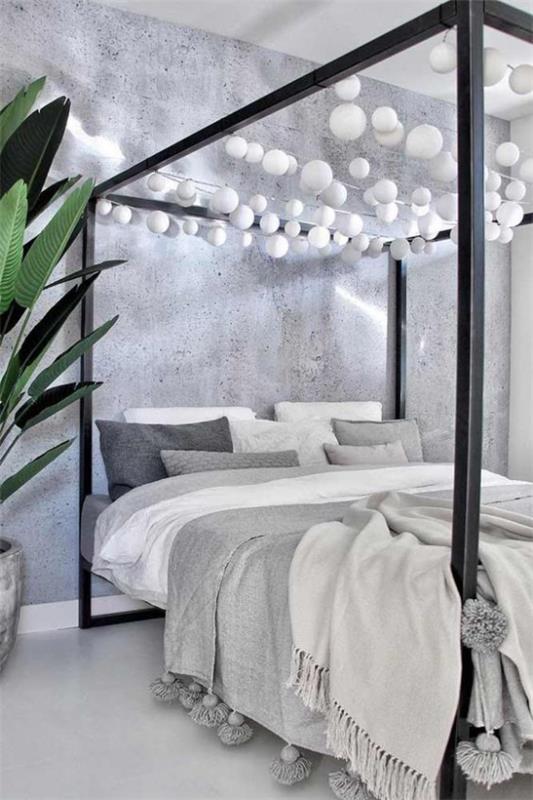 Sypialnia z baldachimem w kolorze szarym, białym, pięknym wzorem, duże zielone pom-poms