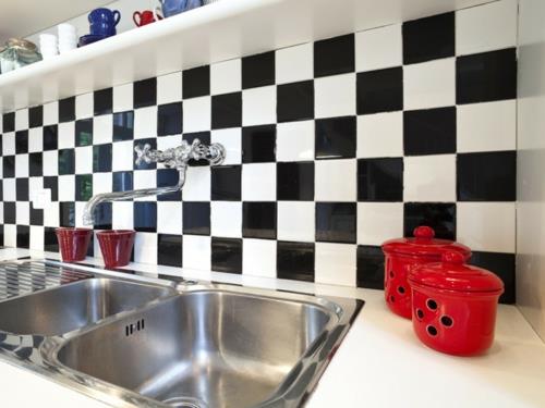 Montaż czarnej i białej podwójnej umywalki w tylnej ścianie kuchennej