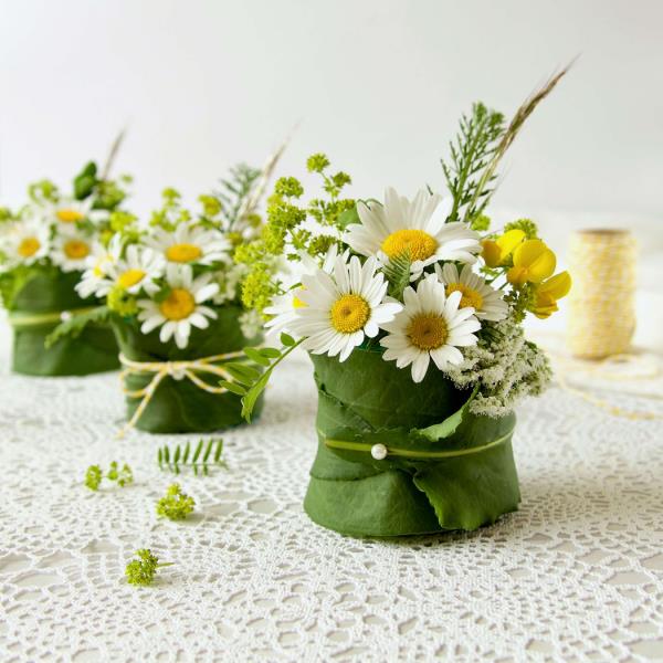 Les marguerites blanches en bouquets sont la décoration de table parfaite pour une occasion festive
