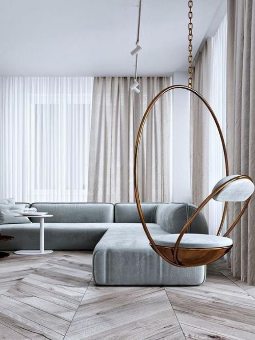 Minimalizm w salonie, perfekcyjny design, zredukowane meble, wiszące krzesło na pierwszym planie