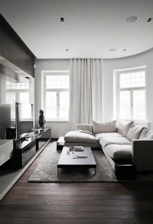 Minimalizm w salonie idealny projekt biała sofa szary dywan czarny stół szare zasłony