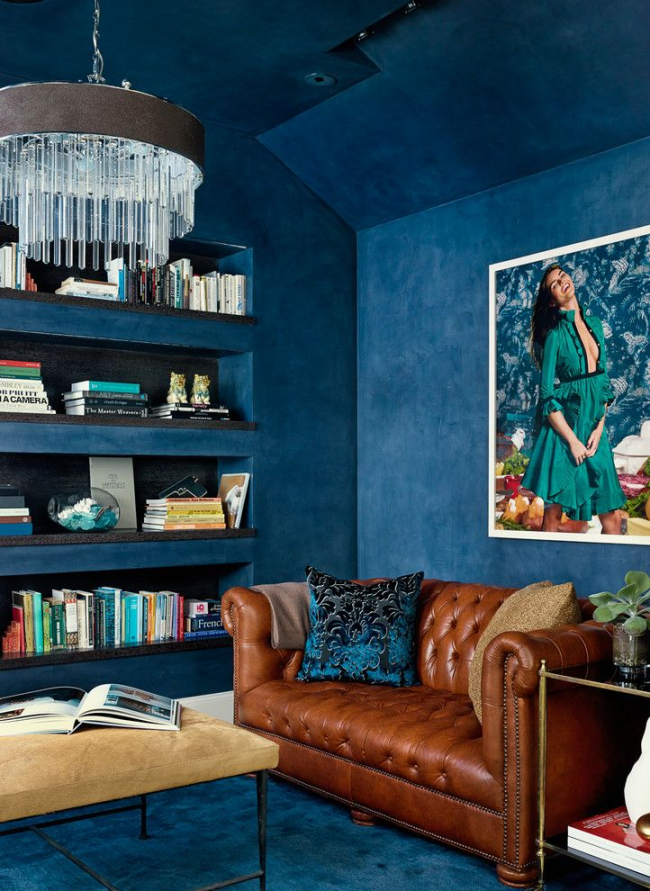 Krásný interiér ve stylu modré fúze s malou hnědou pohovkou Chesterfield