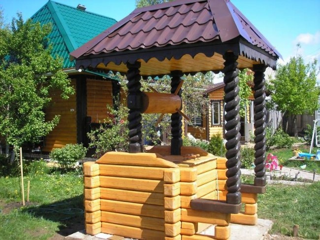 Brunnenhaus mit Holzschnitzereien