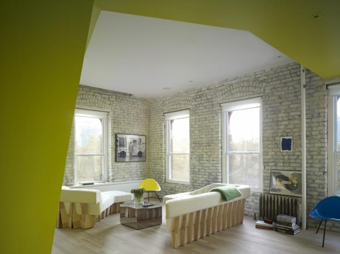appartement d'une pièce mis en place loft mur de briques blanc canapé canapé meubles en bois
