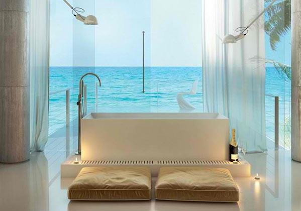baignoire autoportante salle de bain moderne coussins de sol murs de verre vue sur l'océan moma design