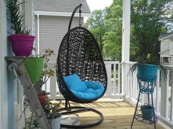 chaise suspendue avec cadre rotin véranda coussins bleus