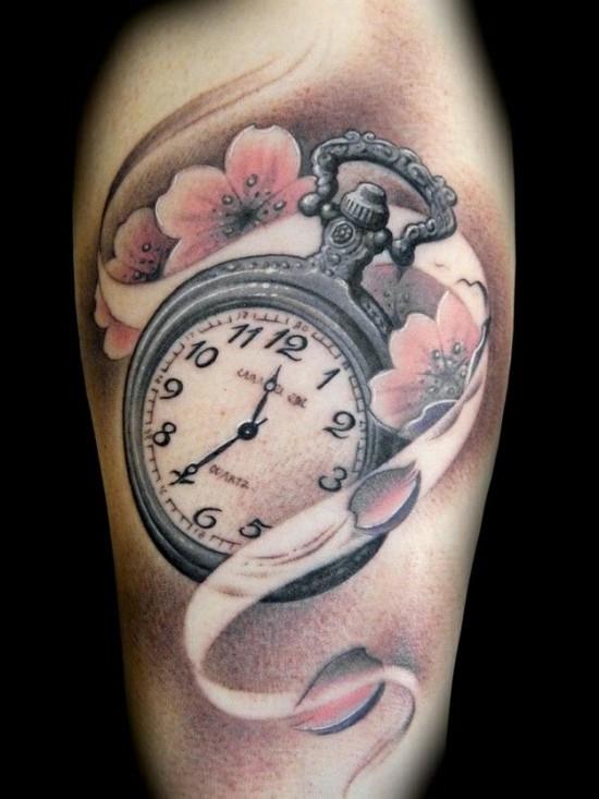 tatuaż kwiat wiśni z zegarem na ramieniu