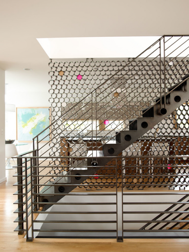 Designumzug zur Zonierung von Freiflächen im Haus: eine Metalltreppe und eine Trennwand im Innenraum