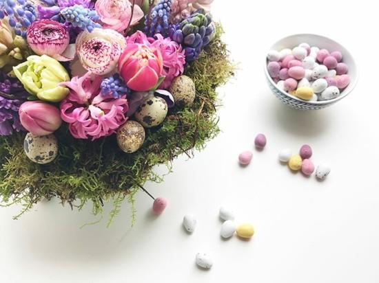 zrównoważona dekoracja stołu wielkanocnego świeże kwiaty jajka przepiórcze mech