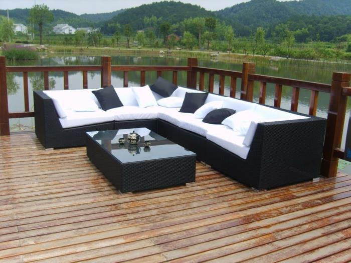 sofa rattanowa sofa narożna ogrodowa białe poduszki do siedzenia czarne poduszki do rzucania